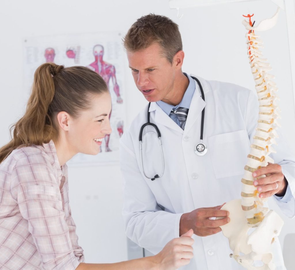 Schedule Appointment - image doctor-explaining-anatomical-spine-his-patient-FILEminimizer-1024x935 on https://trydecompression.com